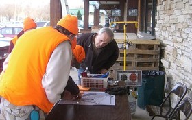 Hunters registering their deer at Sauk Prairie Fish and Game show DNR Secretary Matt Frank where they hunted Saturday.